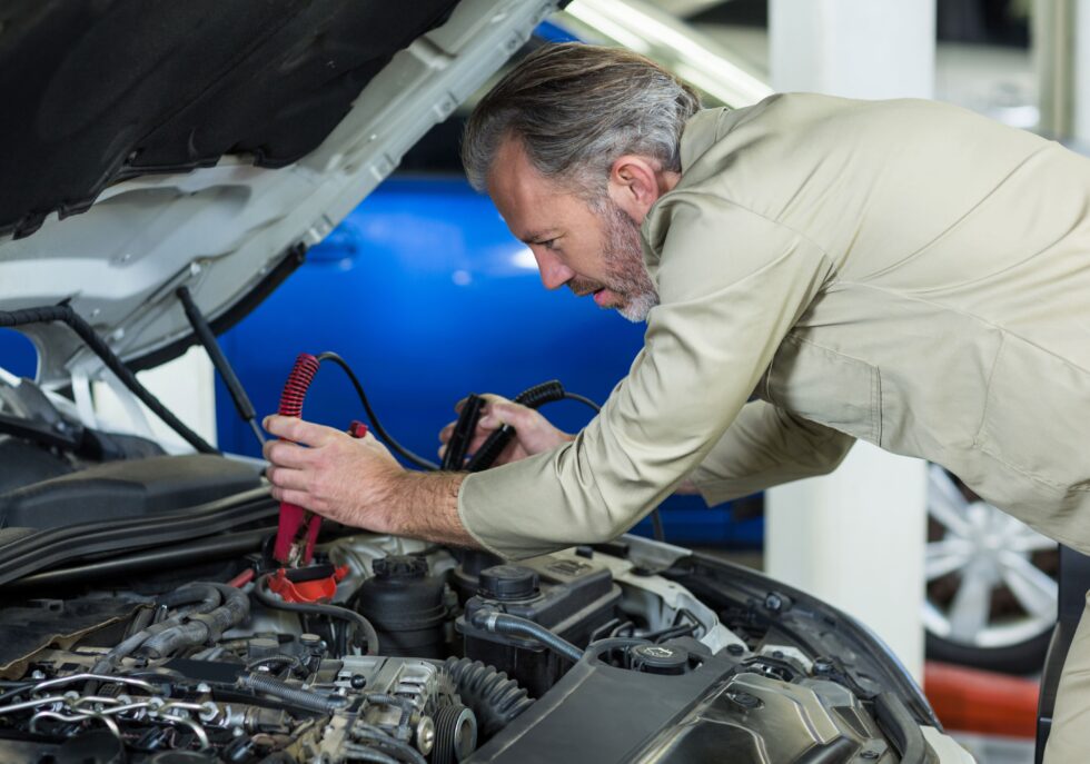 Neil Arnold Tyres And Autos Mechanic jump starting car battery