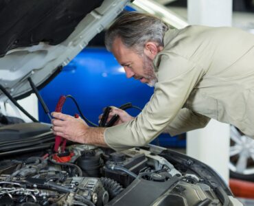 Neil Arnold Tyres And Autos Mechanic jump starting car battery