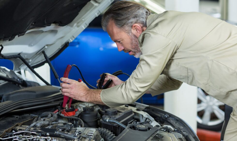 mechanic-attaching-jumper-cables-car-battery-min Neil Arnold Tyres And Autos Mechanic jump starting car battery